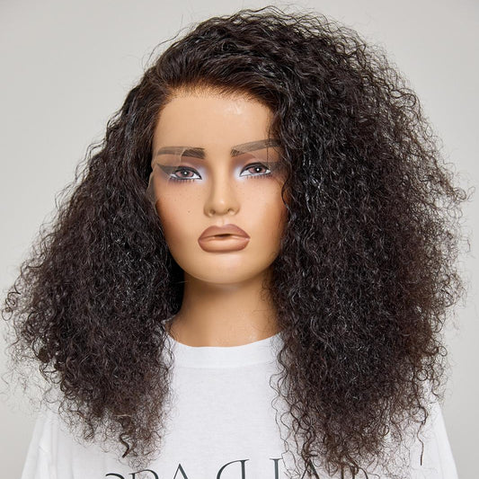 Mannequin head with curly black hair on a plain background